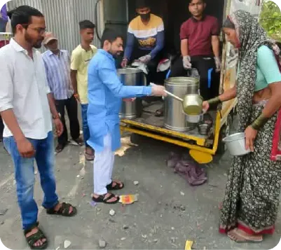 Volunteers posing near a vehicle during a food distribution drive